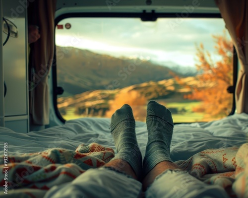 Lonely traveler s legs with sock resting in motorhome bed in autumn in New Zealand photo