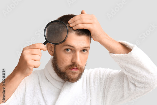 Young man in bathrobe with ...