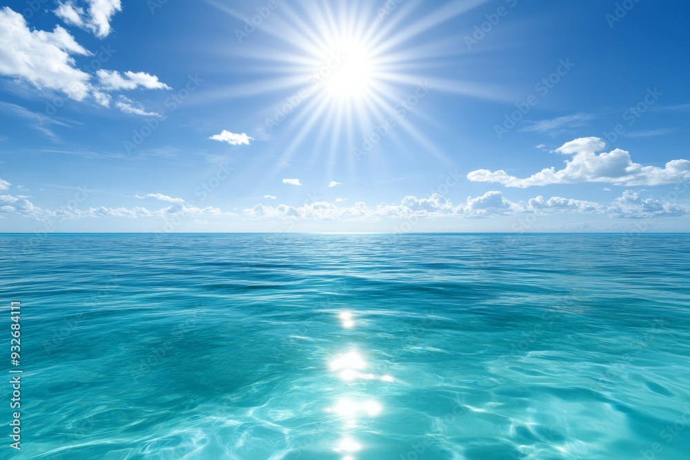 Fototapeta premium Serene Ocean with Clear Blue Waters and Bright Sunlight, Reflecting Light on the Horizon with Scattered White Clouds