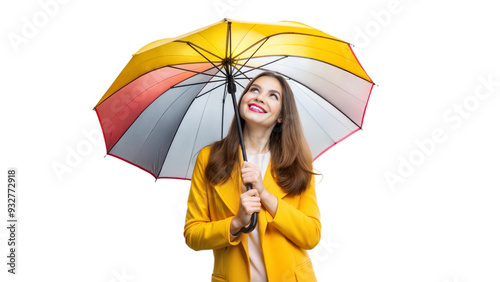 Smiling woman in yellow coat holding a colorful umbrella, staying cheerful in rain photo