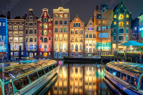 Obraz na płótnie Old houses of Amsterdam. The houses stand in the water and have a beautiful reflection. Touristic district Damrak. These houses are famous all over the world. Amsterdam, Holland, Europe w salonie