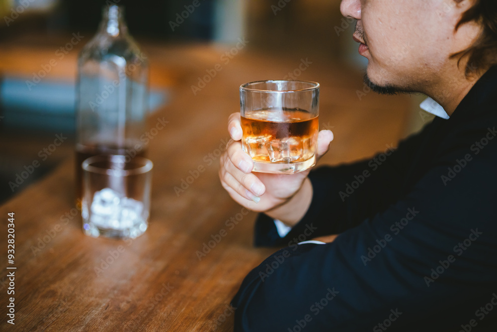 A young businessman holds a glass of whiskey, toasting with friends at an upscale bar. The scene captures the essence of luxury and celebration, with a focus on camaraderie and the nightlife atmospher A young businessman holds a glass of whiskey, toasting with friends at an upscale bar. The scene captures the essence of luxury and celebration, with a focus on camaraderie and the nightlife atmospher