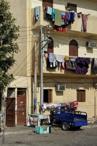 Locals dry clothes on a balcony, Luxor, Egypt. photo