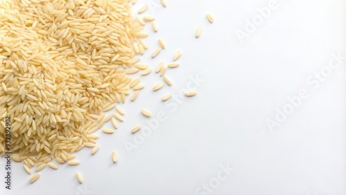 A Heap of Uncooked Long Grain Rice on a White Surface photo