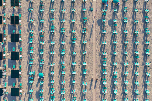 Italy, Tuscany, Torre del Lago Puccini, boathouse and neatly ordered beach chairs and umbrellas