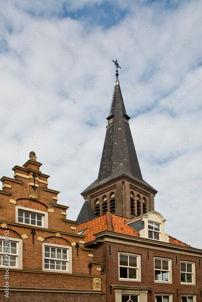 The quaint Dutch village of Monnickendam with the tower of the Grote Kerk (St. Nicolaaskerk) church in the background. The quaint Dutch village of Monnickendam with the tower of the Grote Kerk (St. Nicolaaskerk) church in the background.