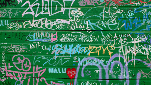 Green door full of unreadable graffiti