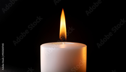 Close up single candle light and flame on black background