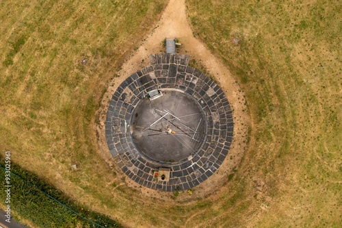  Top-down picture of the historic Martello Tower’s weathered roof, dotted with antennas. The surrounding grassland emphasizes the isolation of this historic structure in Howth, Dublin. photo