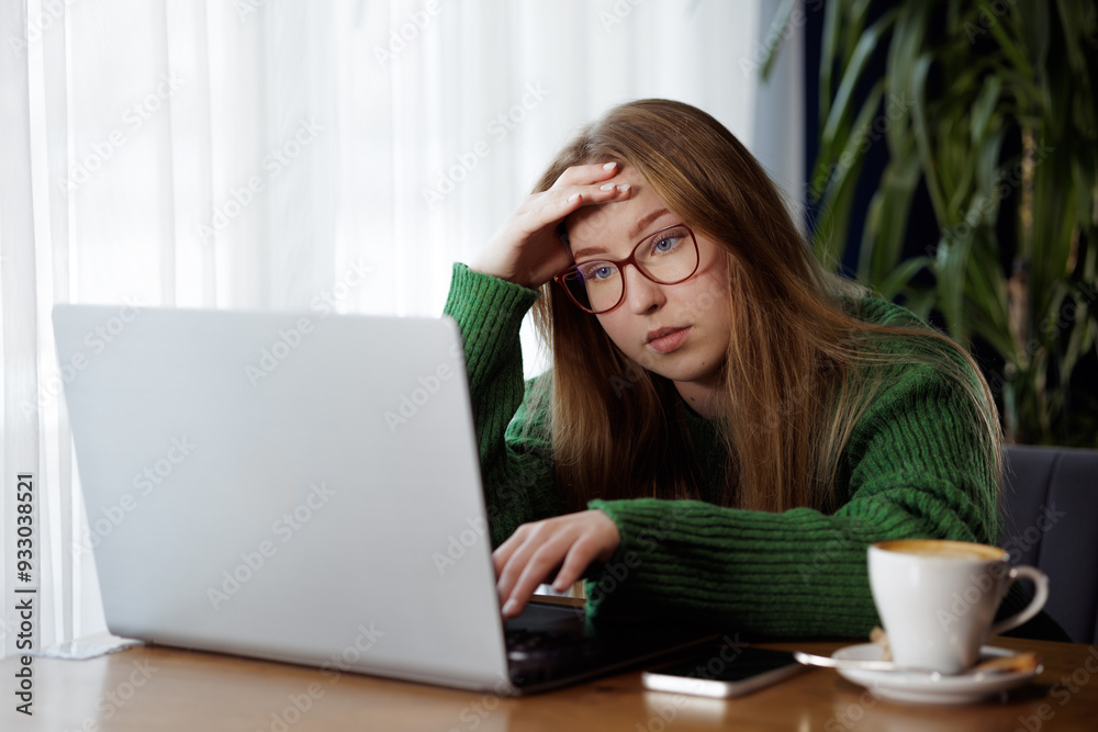 tired girl working online with laptop and drinking coffee, online learning tired girl working online with laptop and drinking coffee, online learning