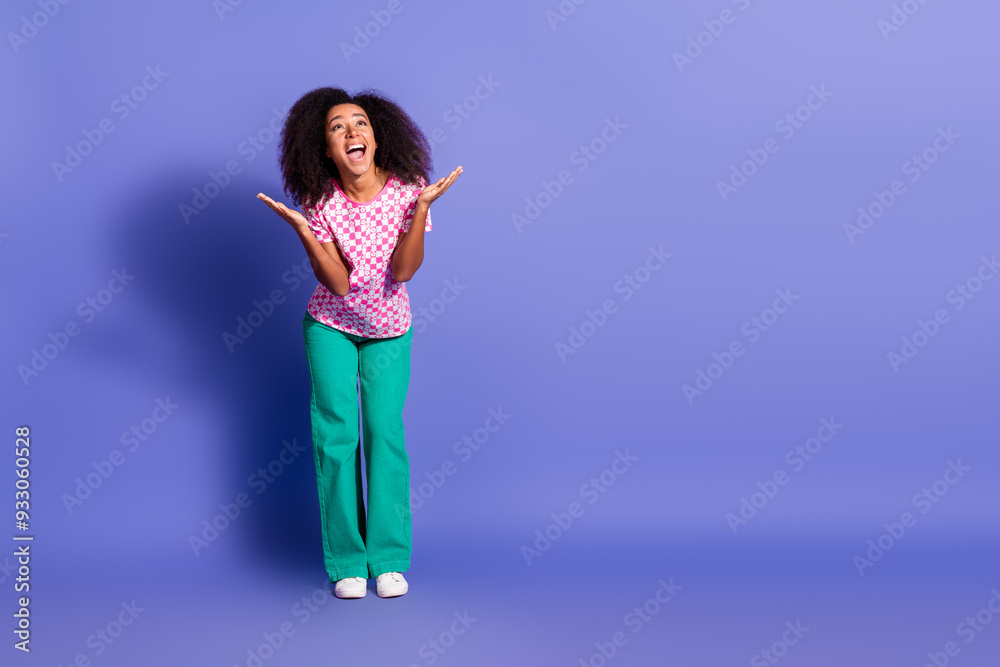 Full size photo of pretty young girl look excited amazed empty space wear trendy pink outfit isolated on purple color background Full size photo of pretty young girl look excited amazed empty space wear trendy pink outfit isolated on purple color background