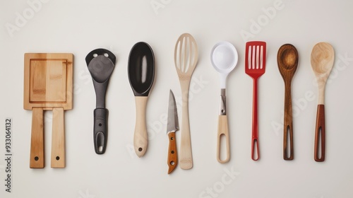 An overhead view of various wooden kitchen utensils neatly arranged in a row on a white background.