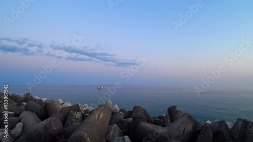 Awesome sunset over the breakwater at the entrance of the harbor in the bay of Marina di Camerota, Salerno, Italy. Video in 4K. photo