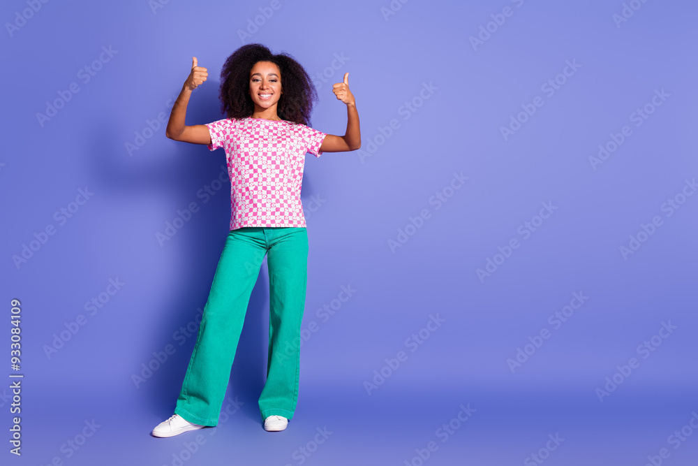 Photo of cheerful satisfied woman wear trendy clothes thumb up empty space isolated on purple color background Photo of cheerful satisfied woman wear trendy clothes thumb up empty space isolated on purple color background