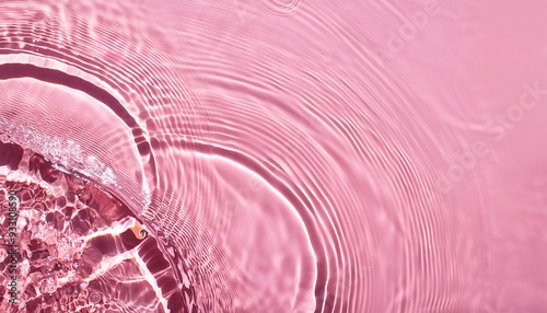 Abstract summer banner background Transparent pink clear water surface texture with ripples, splashes and bubbles. 