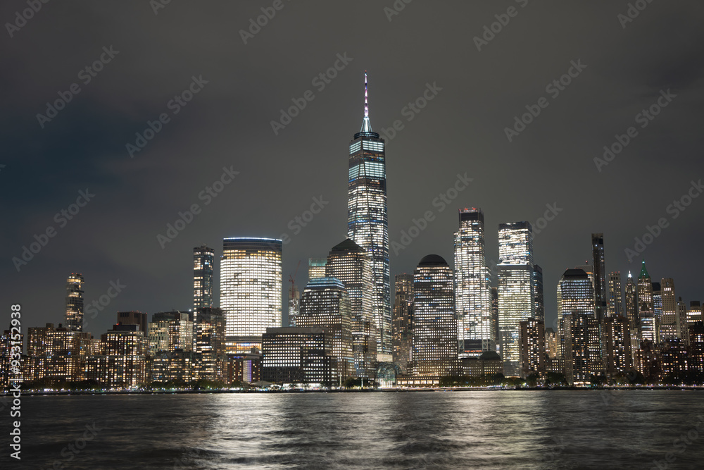 Obraz premium Night in The NYC city, USA, United States. Night day with iconic buildings. New York City NYC Manhattan Downtown Skyline, viewed from Jersey City, USA.