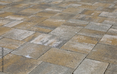 Gray, brown and white concrete paver blocks of different shapes. Stone effect for outdoor flooring, backyard or sidewalk. Background and texture