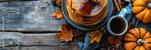 An inviting Thanksgiving breakfast scene with pumpkin spice pancakes, maple syrup, and a hot cup of coffee photo