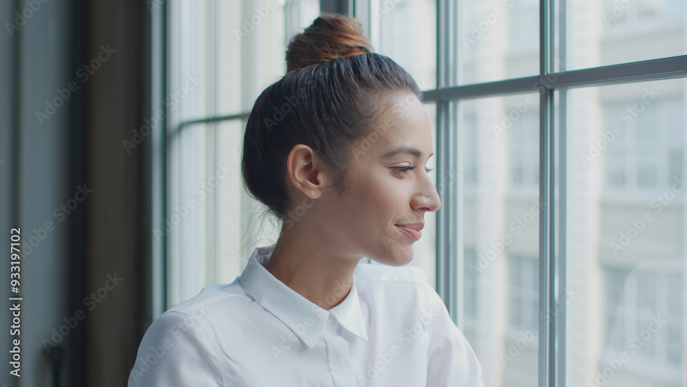 Head And Shoulders Portrait Of Smiling Young Businesswoman Looking Out Of Window In Office Head And Shoulders Portrait Of Smiling Young Businesswoman Looking Out Of Window In Office