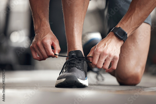 Hands, person and tie shoes at gym for exercise preparation, start workout and training sneakers of cardio. Athlete, fitness and ready feet for running activity, wellness goals and sports performance