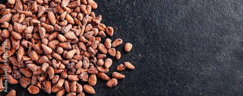 Close-up of raw cacao nibs on a dark background with rich colors, cacao superfood, natural mood booster