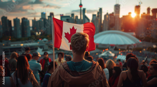 Back view of a teenager in the crowd watches the sunset on Canada Day in Toronto, Ontario