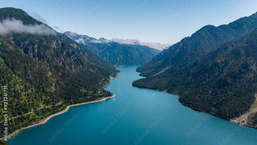 Serene reflection at Plansee Lake in Austria during a calm summer day Serene reflection at Plansee Lake in Austria during a calm summer day
