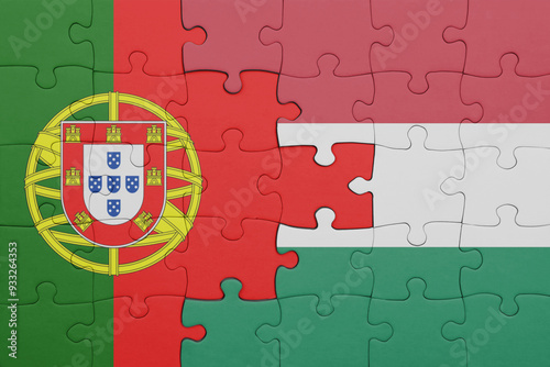 puzzle with the colourful national flag of hungary and flag of portugal . photo