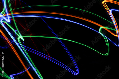 Light Painting Photography - swirly waves of neon multicolor light against a black background