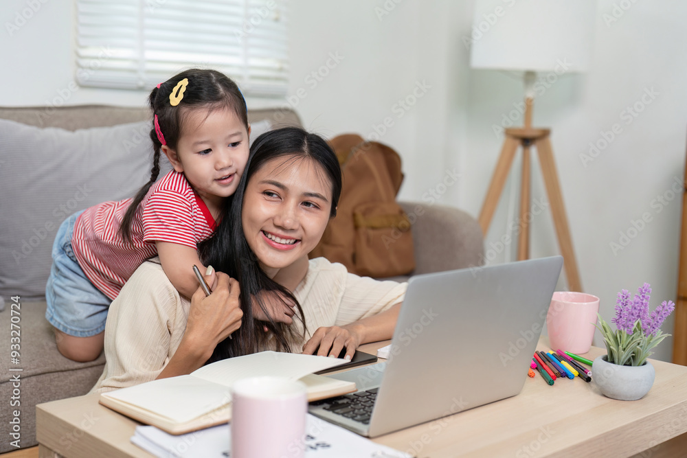 Mother and Daughter Enjoying Quality Time Together While Working from Home on a Laptop in a Cozy Living Room Setting Mother and Daughter Enjoying Quality Time Together While Working from Home on a Laptop in a Cozy Living Room Setting