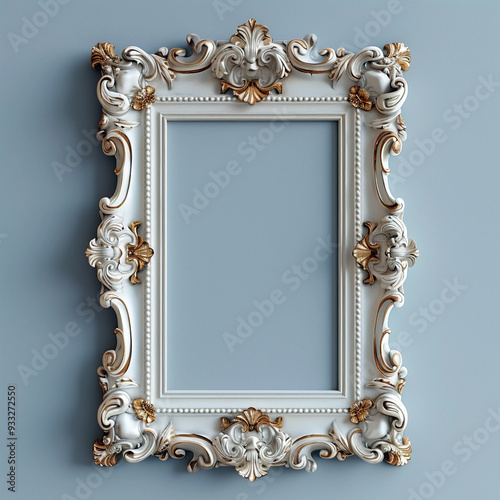 A white frame with gold trim sits on a blue wall