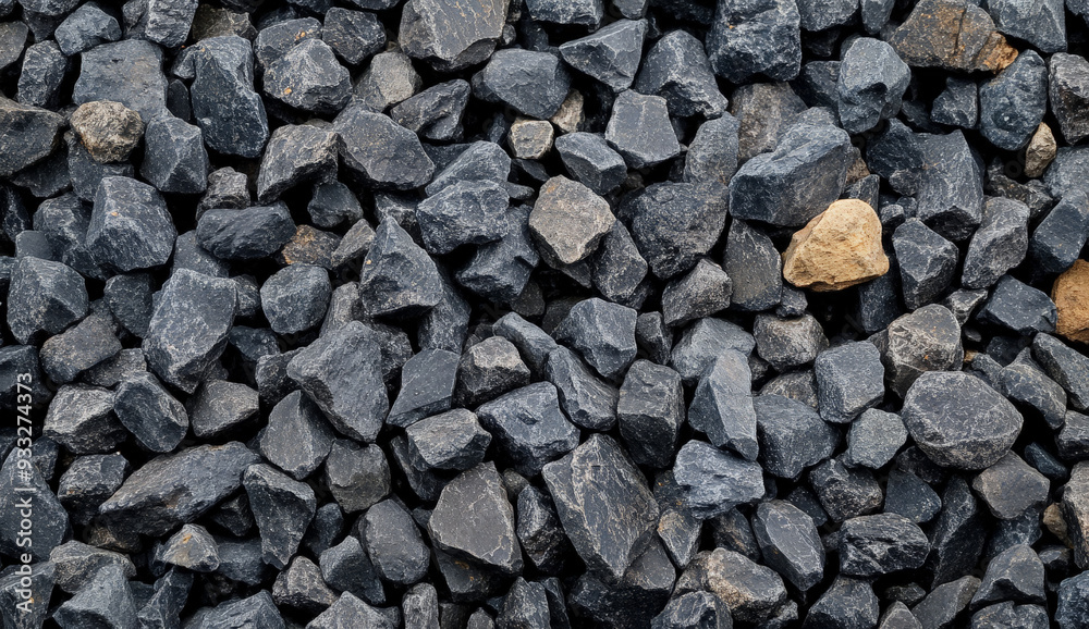 Close-up of a pile of grey gravel with a few tan stones.