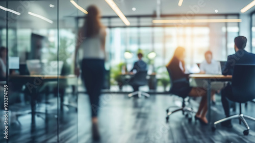 Blurred business modern office with a glass-walled conference room and blurred people casual wear
