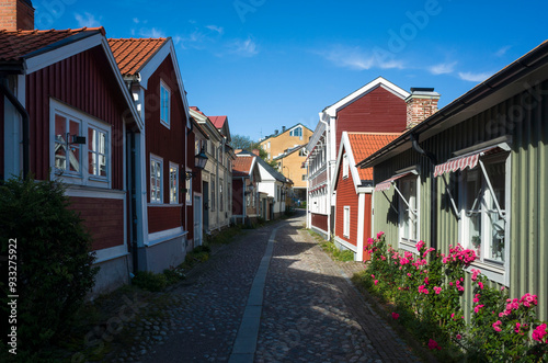 Old town in Sweden, Cozy street with traditional colorful timber houses in Gamla Gefle quarter of Gävle city on summer sunny day