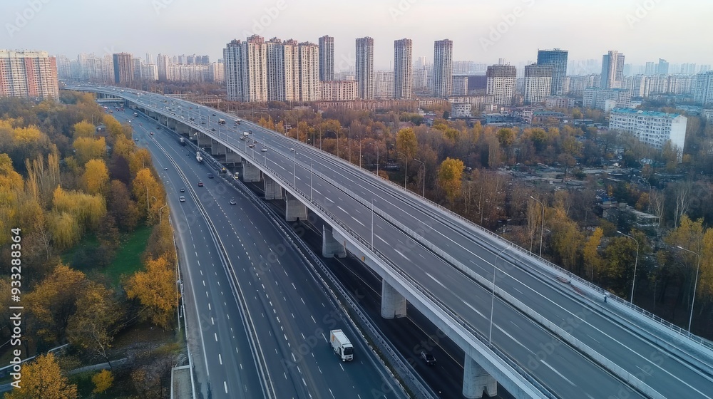 Fototapeta premium Aerial view of a multi-lane highway in the city with high rise apartment buildings on each side.