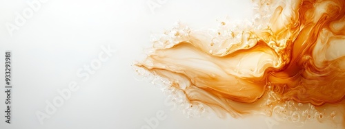  A tight shot of white and orange liquids overlapping in a white background, both liquids being predominantly white and orange photo