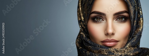  A woman closely wearing a headscarf, one covering her head, the other around her neck