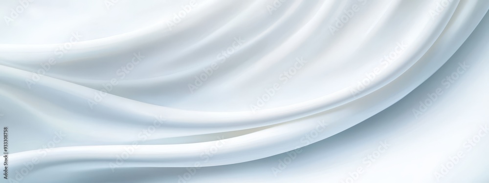 A tight shot of a white fabric, featuring a vaguely discernible design at its bottom edge A tight shot of a white fabric, featuring a vaguely discernible design at its bottom edge
