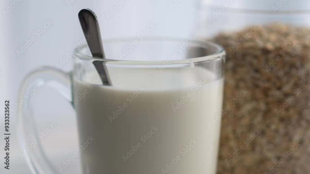 Oatmeal and a glass of milk, close-up.
Healthy breakfast
Glass with warm milk on a table in a white room