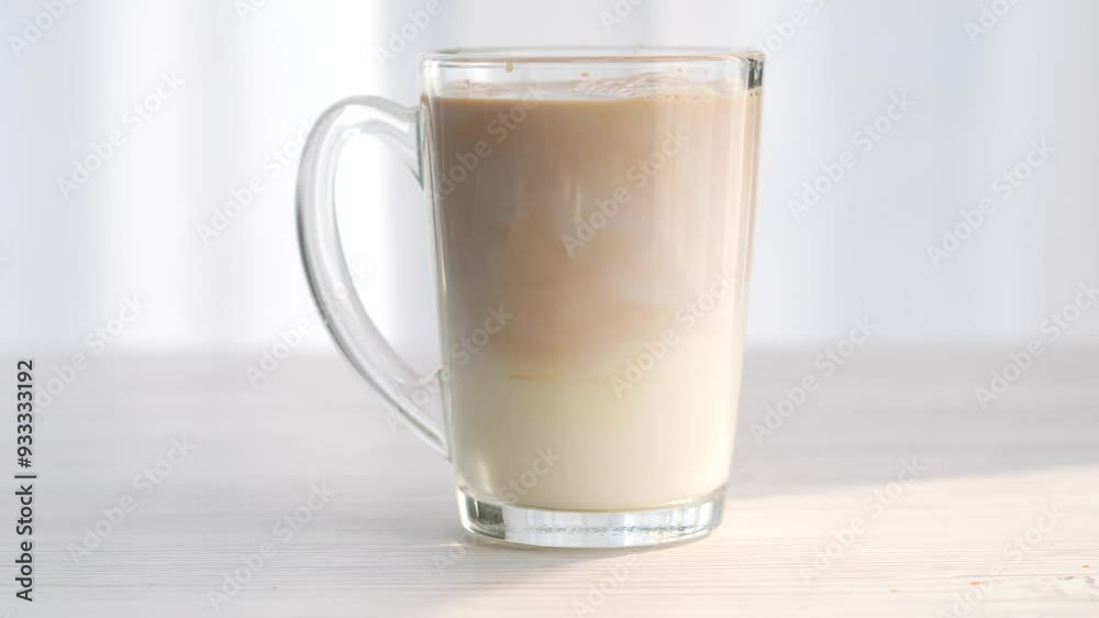 Latte in a transparent glass close-up.
Milkshake.
White background and transparent glass Latte in a transparent glass close-up.
Milkshake.
White background and transparent glass