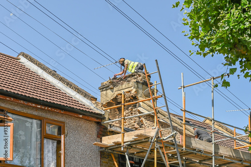 Workers remove chimney roof. London, UK, 29 July 2024