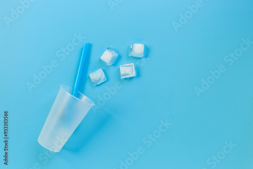 Disposable cup with ice and straw for cocktails. Cold drink concept