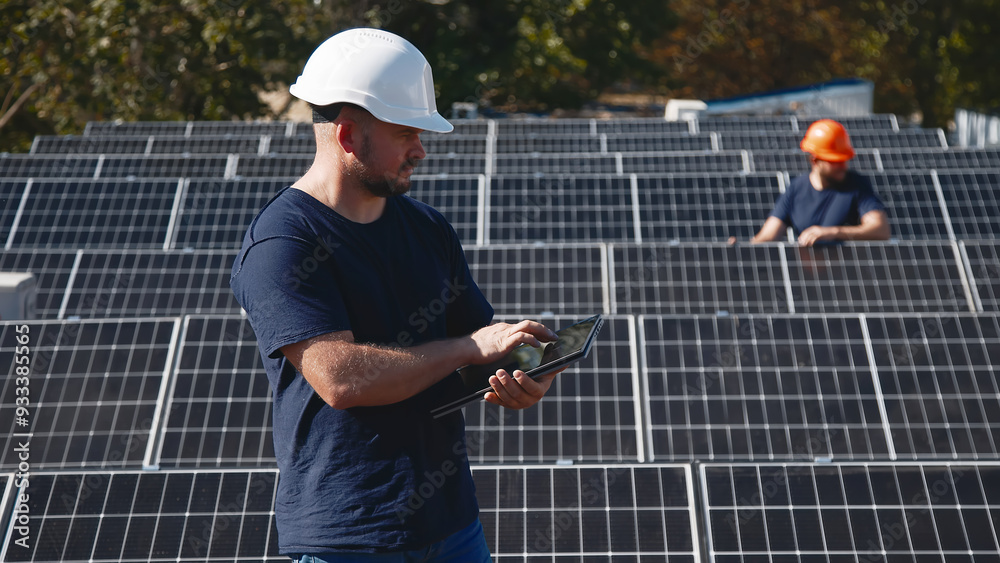 Professional engineers inspect solar panel installation on a rooftop under sunlight. Detailed check of the solar system setup for efficiency and quality. Professional engineers inspect solar panel installation on a rooftop under sunlight. Detailed check of the solar system setup for efficiency and quality.