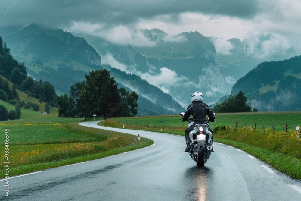 A person riding a motorcycle on a wet road, with rain pouring down A person riding a motorcycle on a wet road, with rain pouring down
