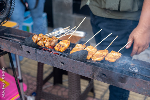 Closeup of Tofu and Meatballs Grilling on a Charcoal Grill photo