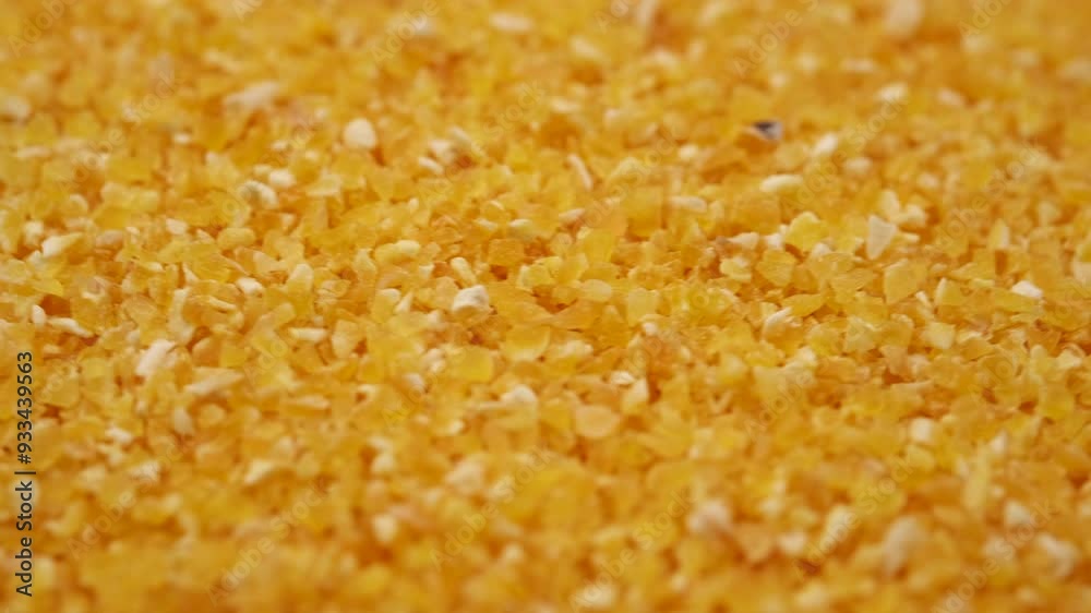 Close up of bright yellow small corn grits texture circle rotation. Eco food concept. Selective focus Close up of bright yellow small corn grits texture circle rotation. Eco food concept. Selective focus