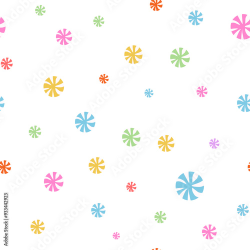 Seamless confetti pattern from multi-colored candies on a white background.