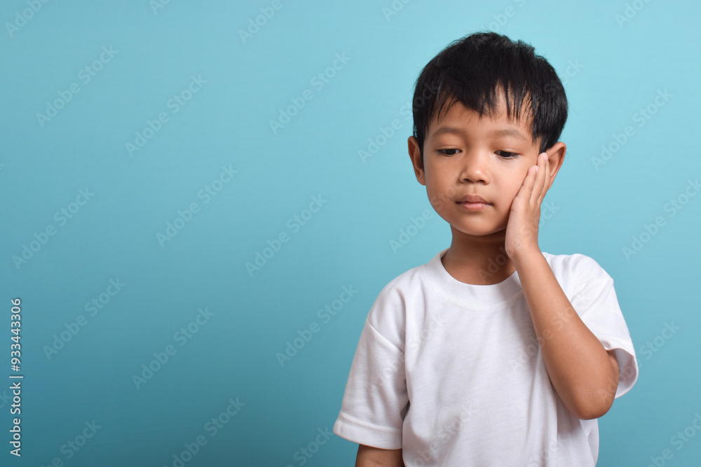 Little Asian boy suffering from toothache. emotional Asian boy who is suffering. A sad child with a toothache. Dental problem. A place for your text. Little Asian boy suffering from toothache. emotional Asian boy who is suffering. A sad child with a toothache. Dental problem. A place for your text.