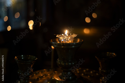 Candles in the Church. Wax candles burning in the dark. Religious atmosphere. photo