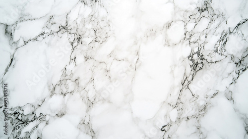 Elegant white marble surface with subtle gray veining in a soft, natural light setting